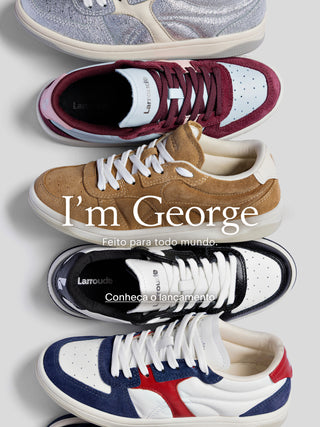 Banner com diferentes modelos de tênis Larroudé lado a lado, em cores e materiais variados como prata metalizado, vinho, camurça caramelo, preto e branco com detalhes em azul e vermelho. Sobreposição de texto: “I’m George. Feito para todo mundo.” e chamada “Conheça o lançamento”.